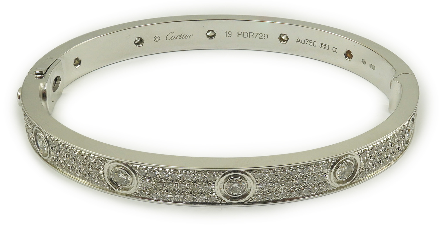 A modern Cartier 18k white gold and diamond cluster set hinged 'Love' bangle